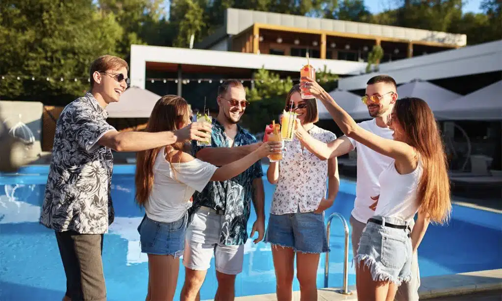 Des colivers au bord de la piscine d'une maison en coliving de luxe